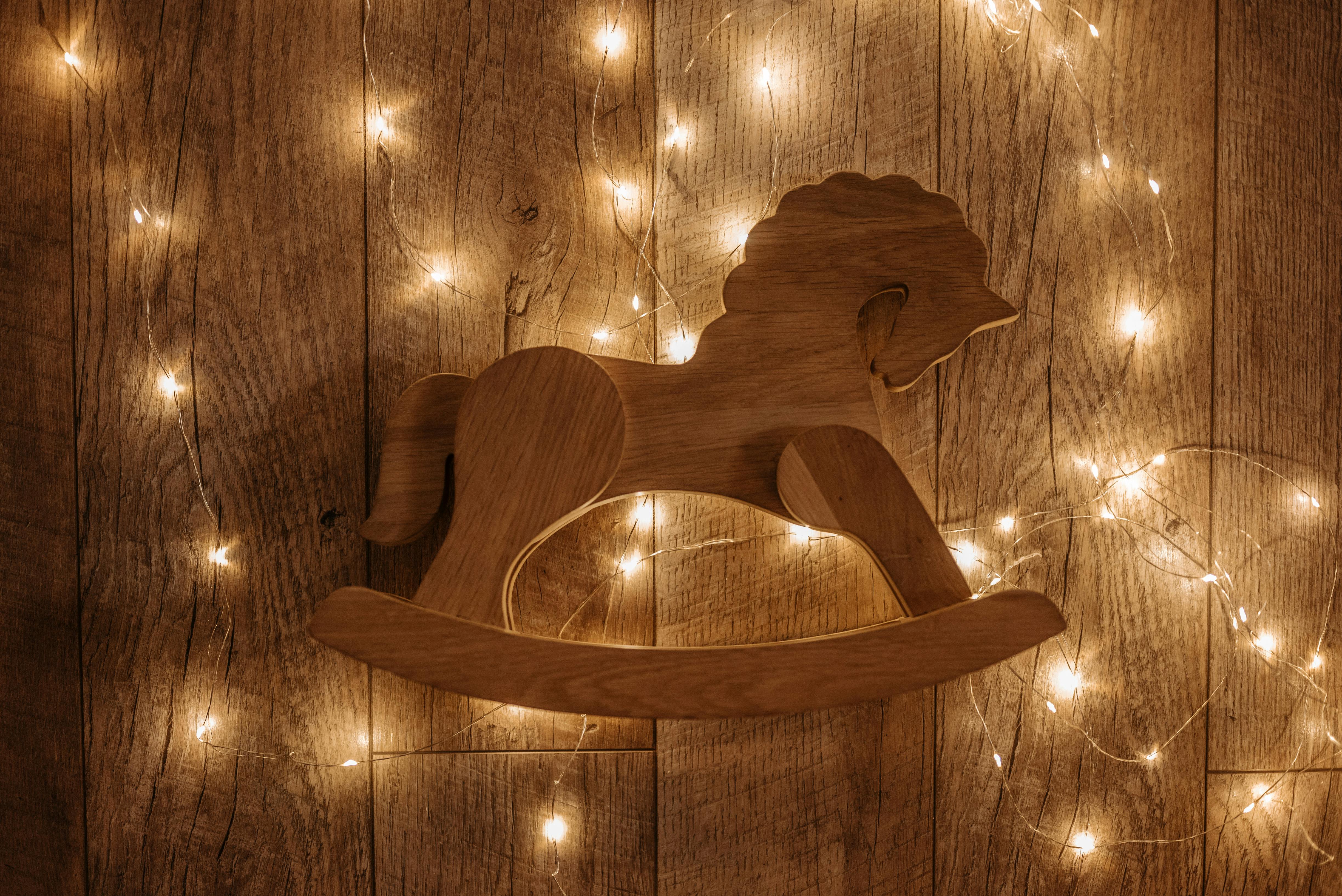 Brown Wooden Rocking Horse Wall Decoration with String Lights · Free
