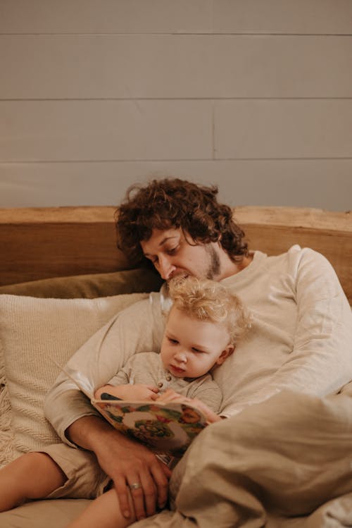 Free A Father and Son Reading Together Stock Photo