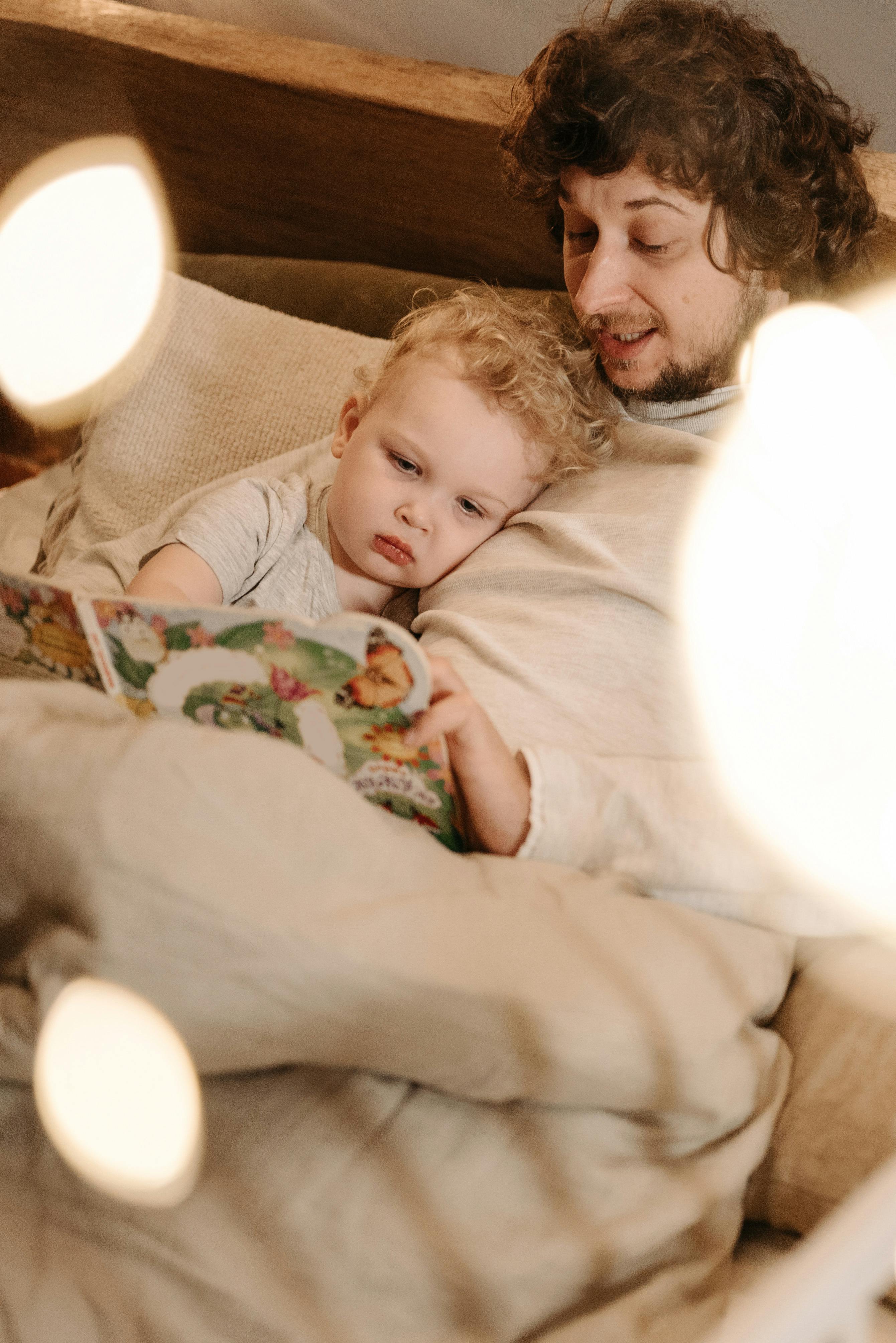 father telling bedtime story to his child