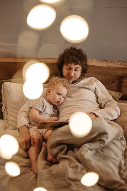 Free Father Telling Bedtime Story to His Child Stock Photo