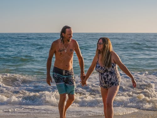 Free A Couple Walking at the Beach Together Stock Photo