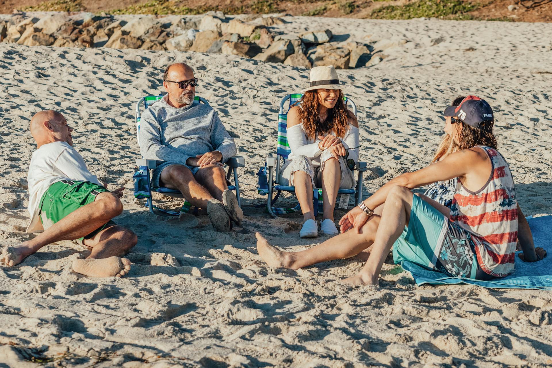 A group of adults enjoying leisure time on a sunny beach, showcasing summer vibes.