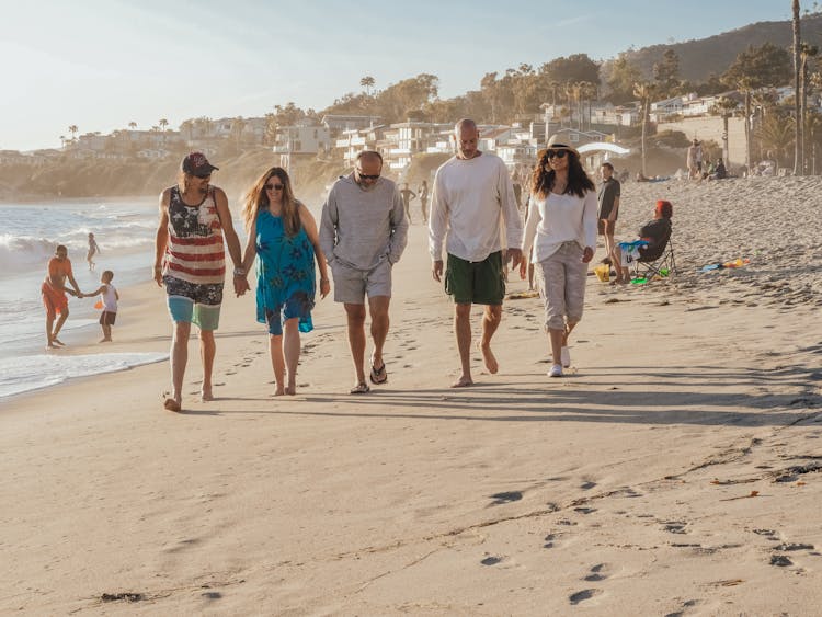 Tourist People Walking On Beach Sand Shore