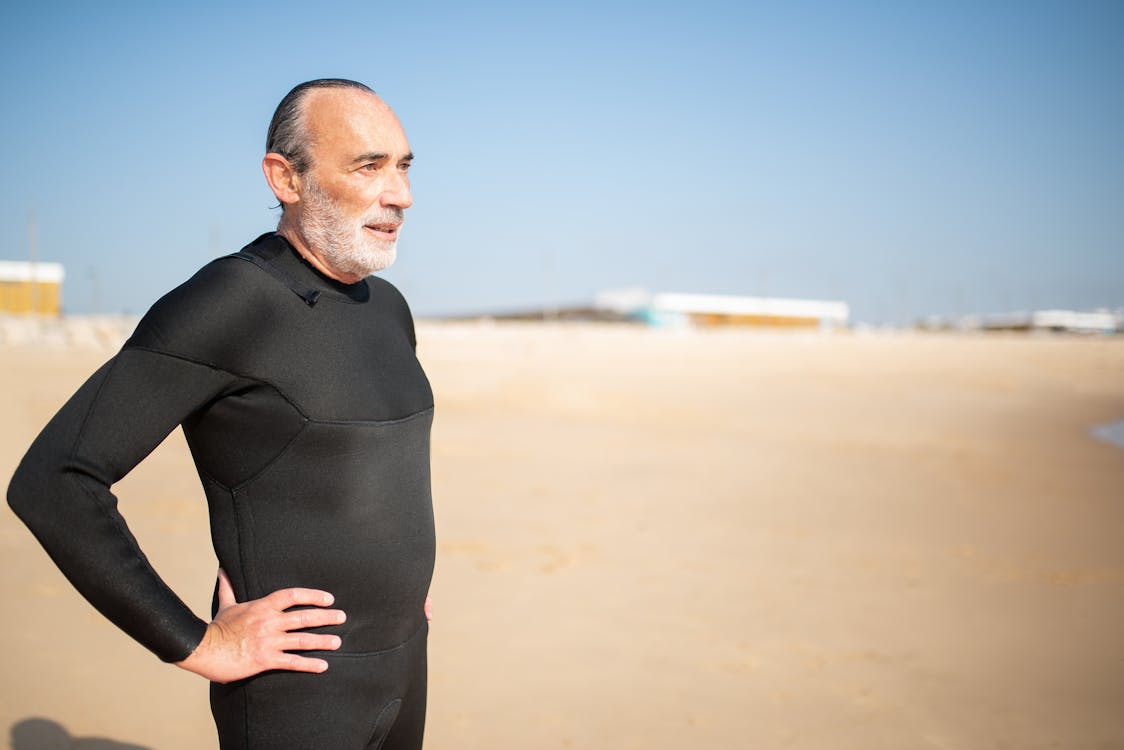 An Elderly Man in Black Wetsuit with His Hand on His Waist · Free Stock ...