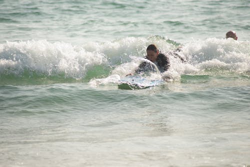 A Person Surfing on the Beach