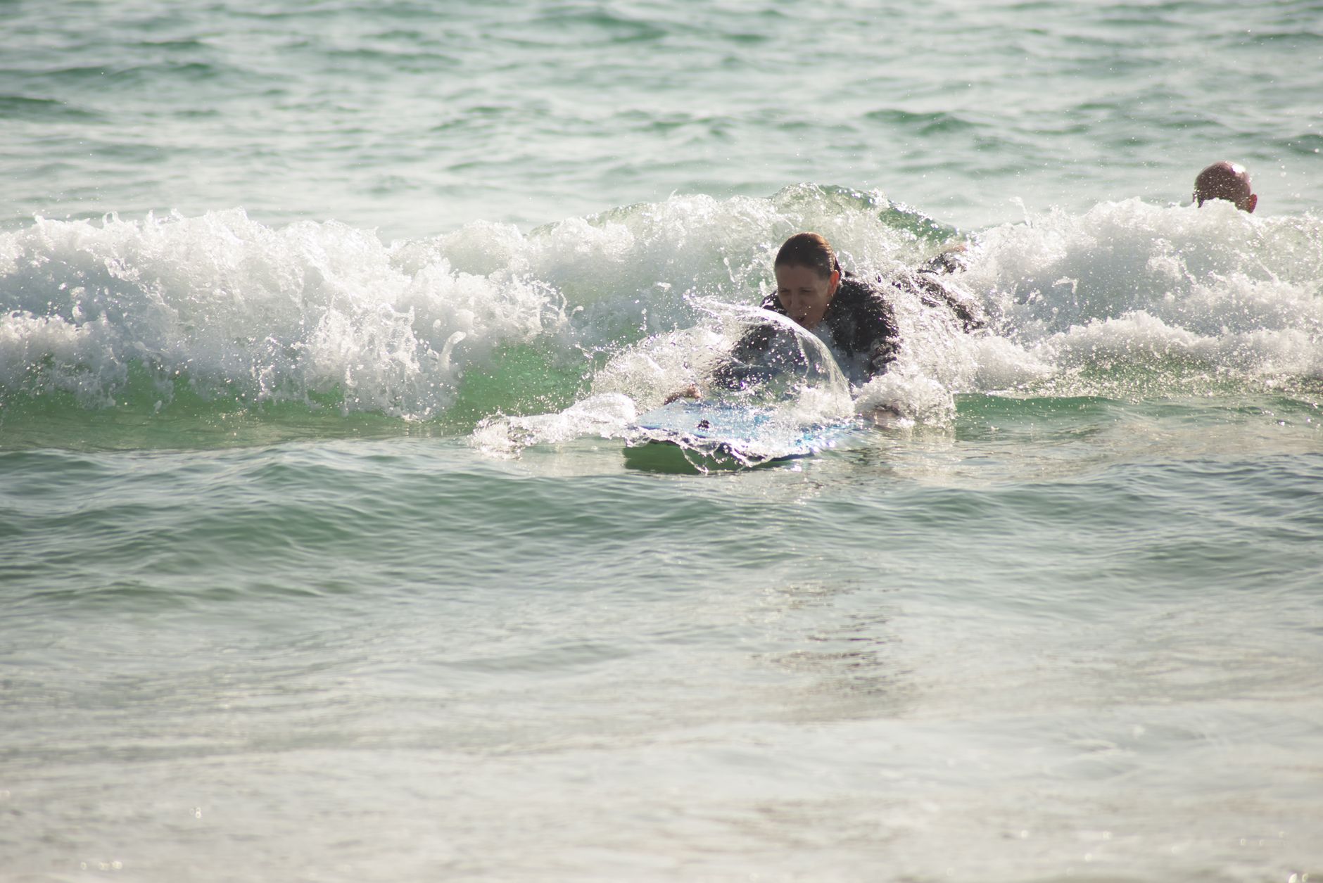 Surf enthusiast catching waves in Portugal, enjoying a sunny day at the beach.