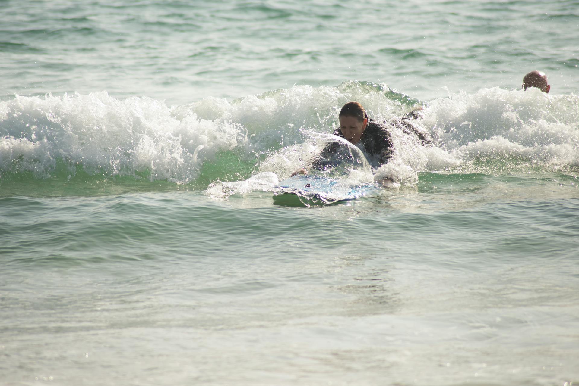 Surf enthusiast catching waves in Portugal, enjoying a sunny day at the beach.