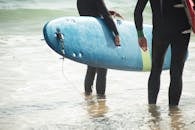 People Holding Surfboards