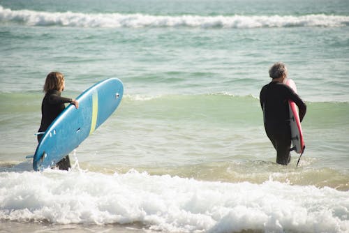 Two People Surfing on the Beach