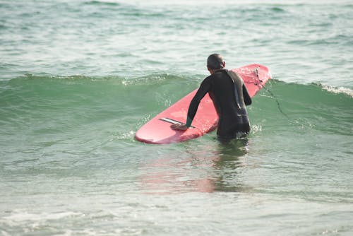 
A Person Surfing on the Beach