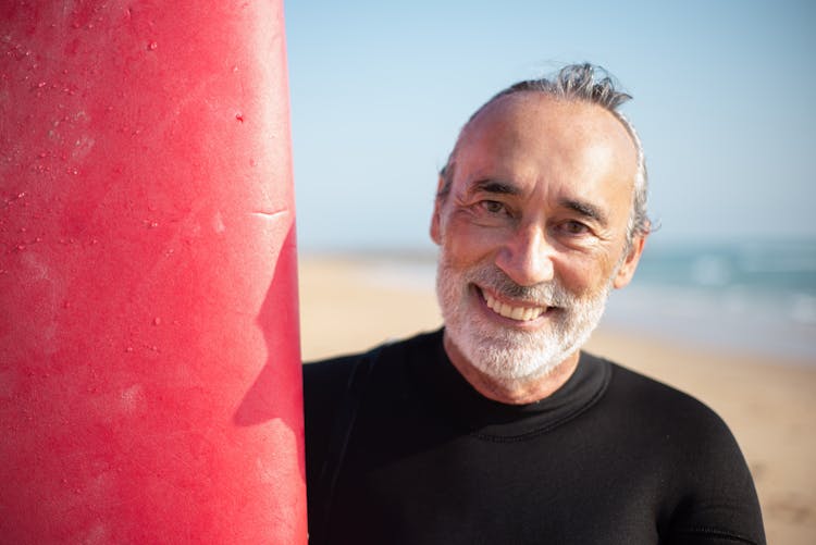 An Elderly Man In Black Shirt Smiling