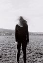 Distorted Photo of Woman Standing on Grass Field