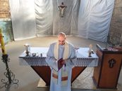 Man in White Thobe Standing Beside Table