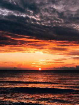 Stunning sunset over the ocean with warm, vibrant colors reflecting on the water.