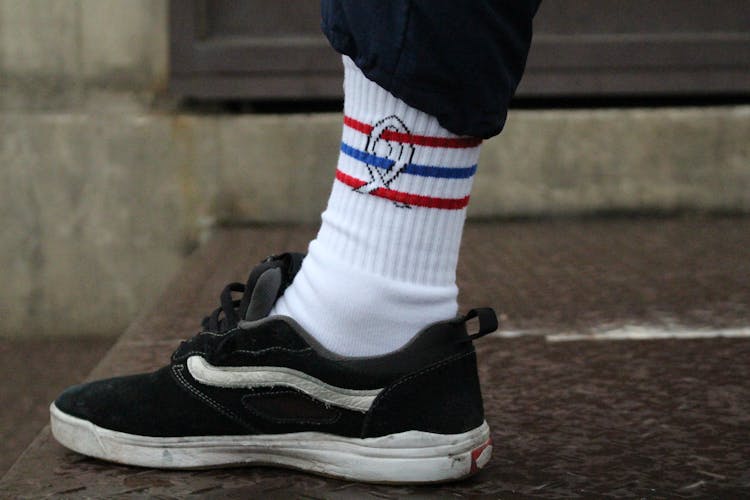 Foot With White Sock And Black Sneaker