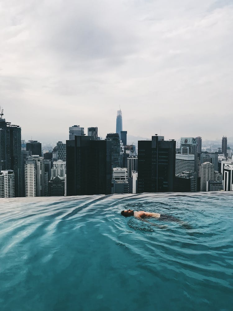 Person Floating On Infinity Pool