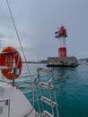 Red and White Lighthouse on Concrete Dock