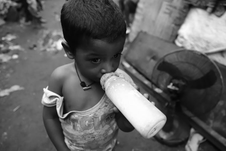 Child Drinking Milk From Bottle