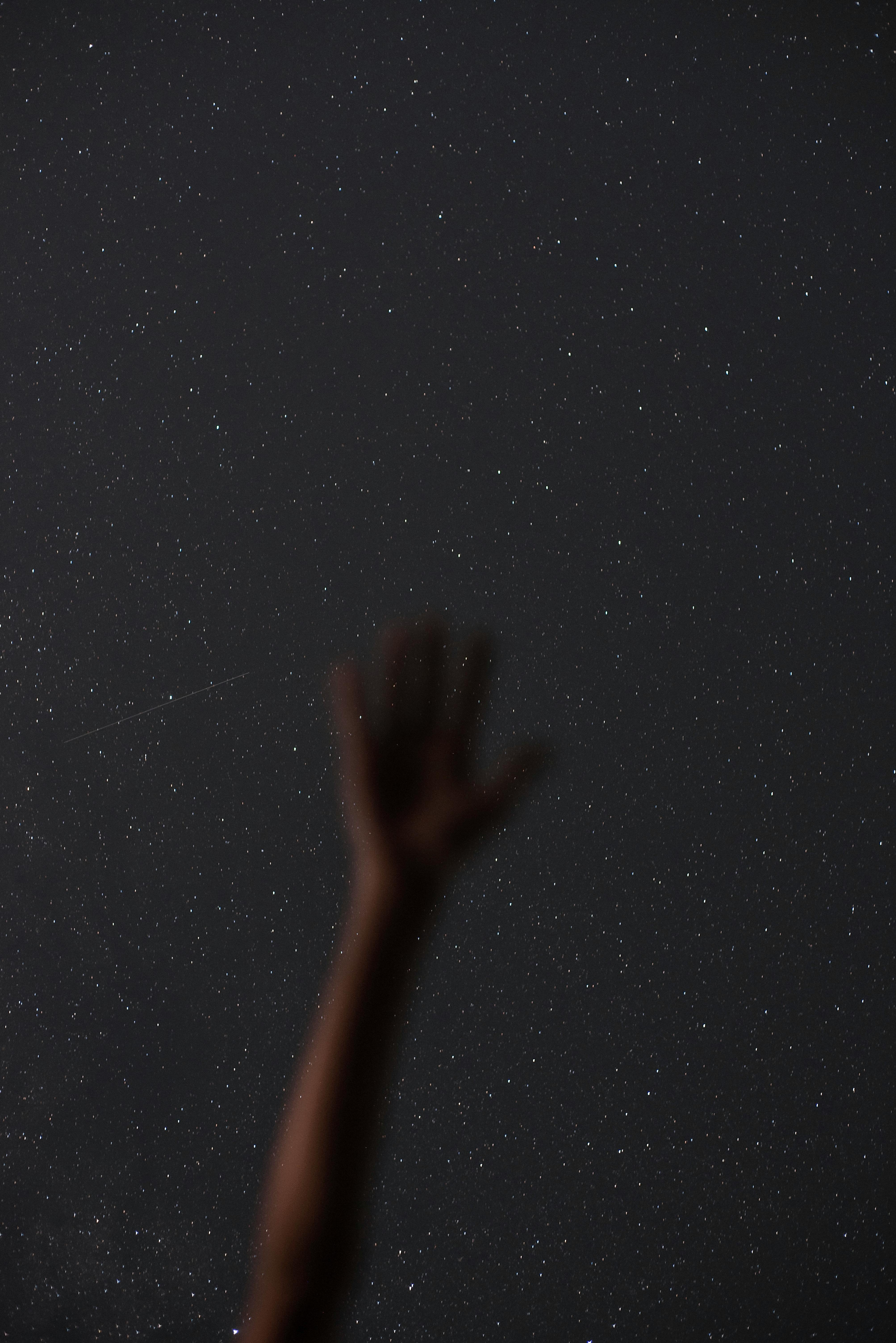 hand against star field