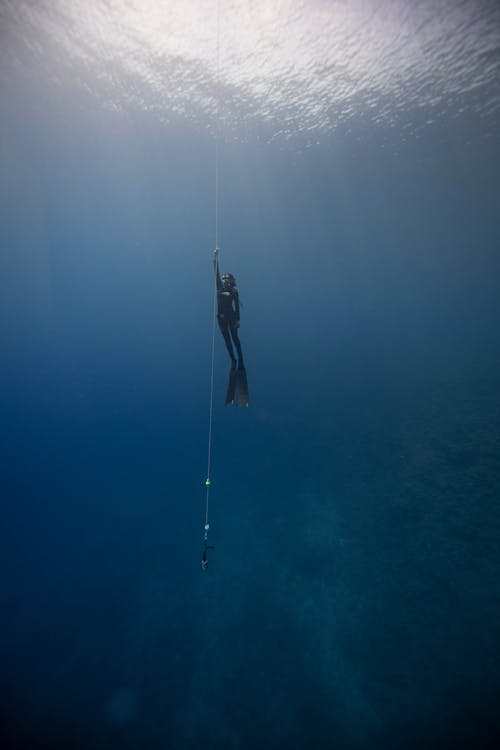 Person Holding Rope Underwater