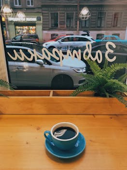 A warm coffee moment by the window in a Saint Petersburg café, overlooking a bustling street.