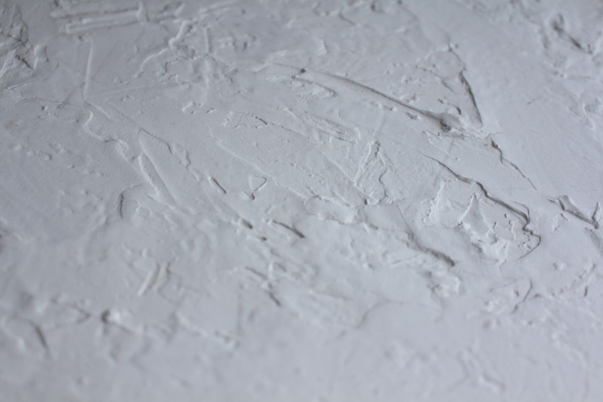 Textured white plaster wall surface