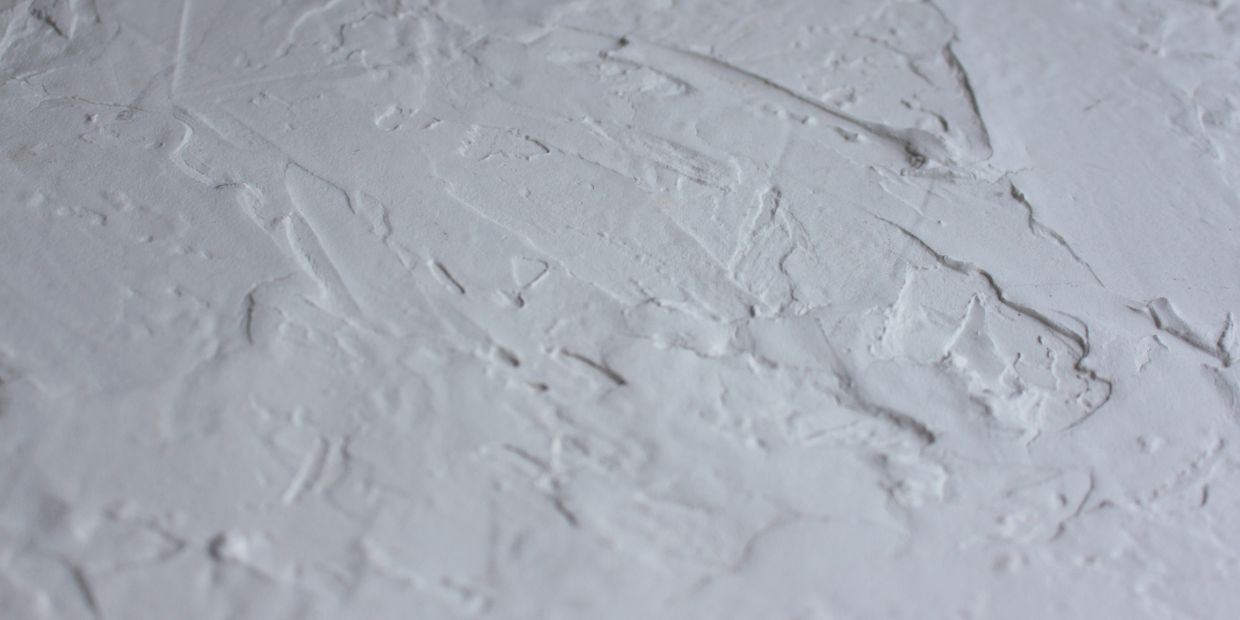 A plaster wall surface, read material by material