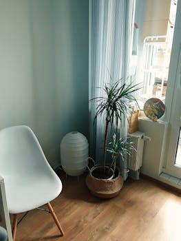 A stylish corner features Scandinavian design with a white chair and potted plant.