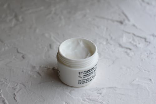 A Face Cream on White Container