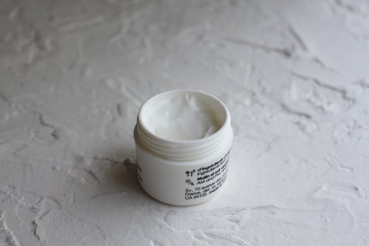 A Face Cream On White Container