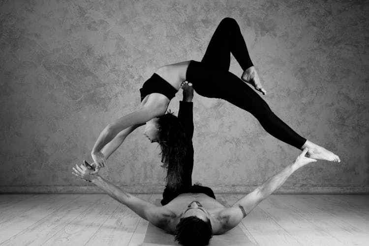 A Couple Doing Yoga Pose In Eye Shape