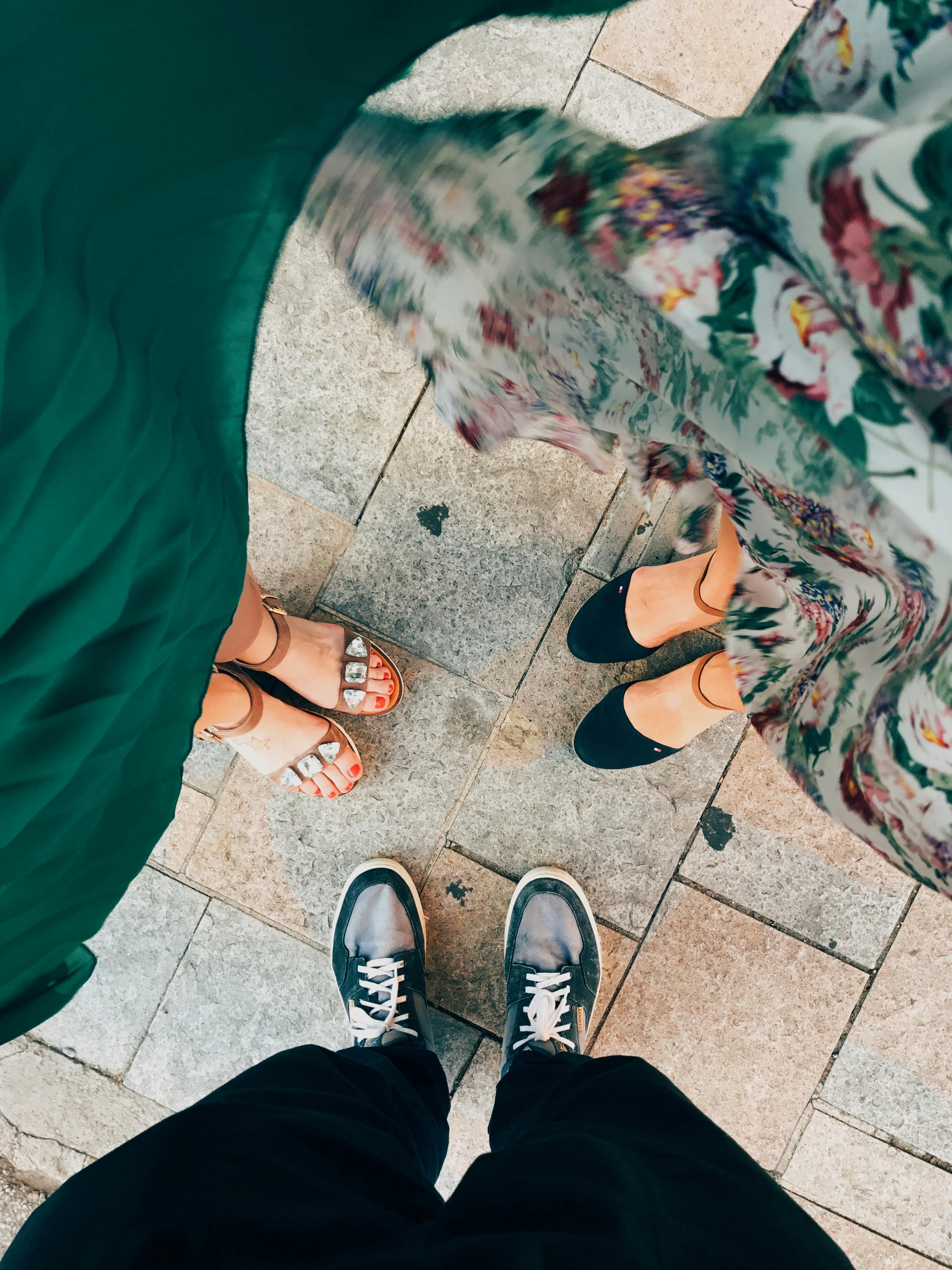 people standing while wearing shoes and sandals