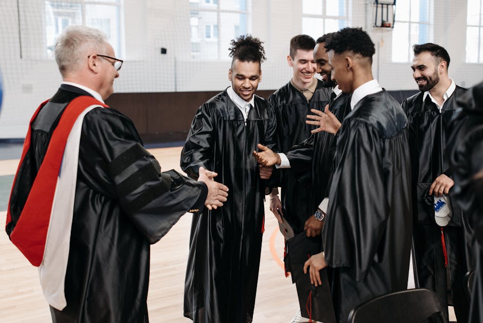 A joyful group of graduates celebrating their achievement. Captured in a gymnasium setting.