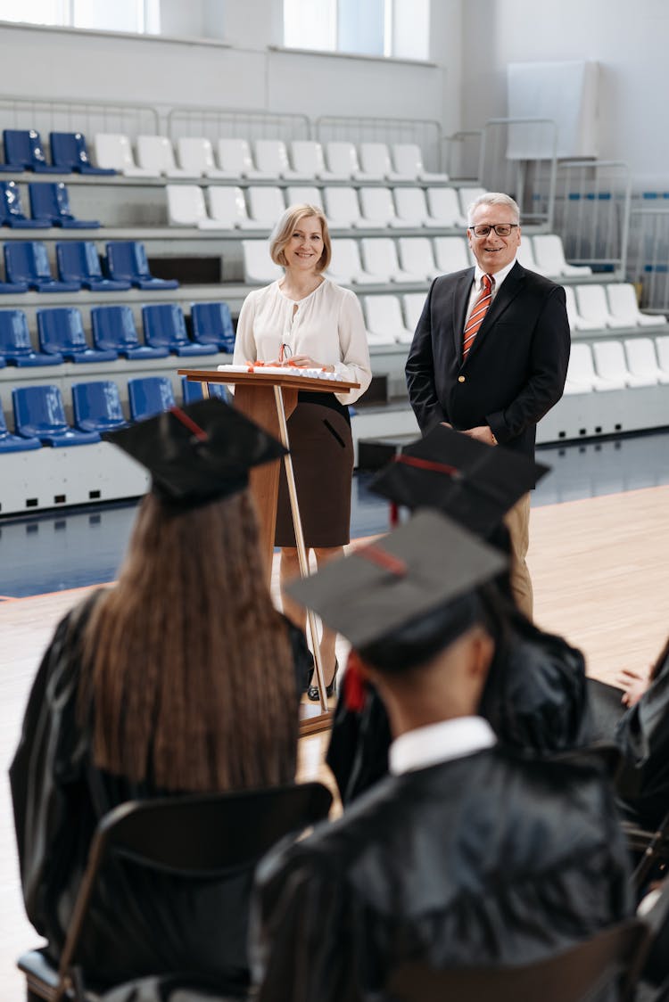 Photo Of School Director And Teacher Standing In Front