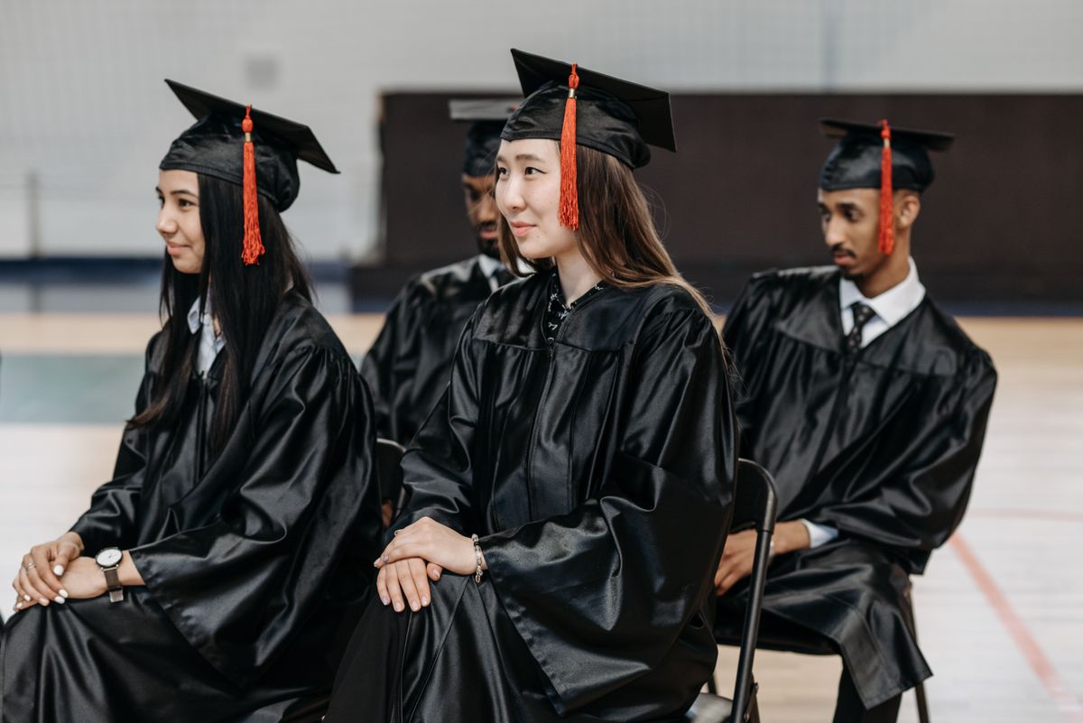 Nursing graduates seated together in gowns before the ceremony