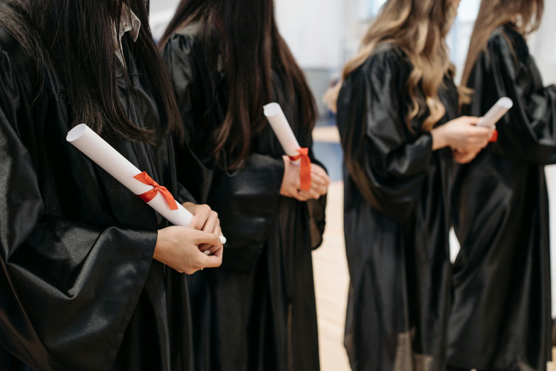 Photo of People Holding Diploma