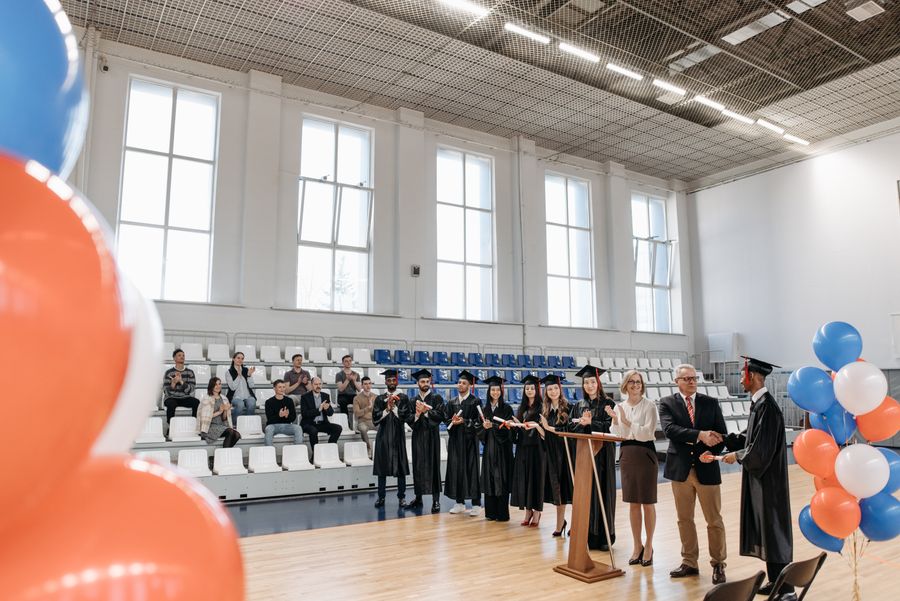 College graduates receiving diplomas at ceremony