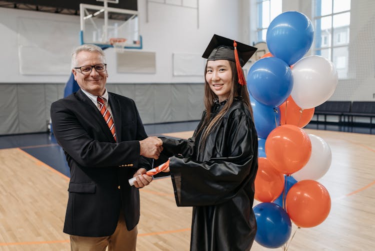 Photo Of Woman Shakes Hands With School Director