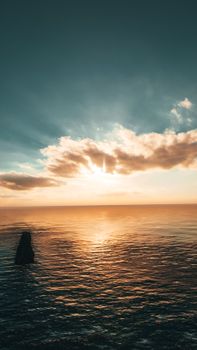 Breathtaking sunrise over the ocean with golden hues and a peaceful sky.