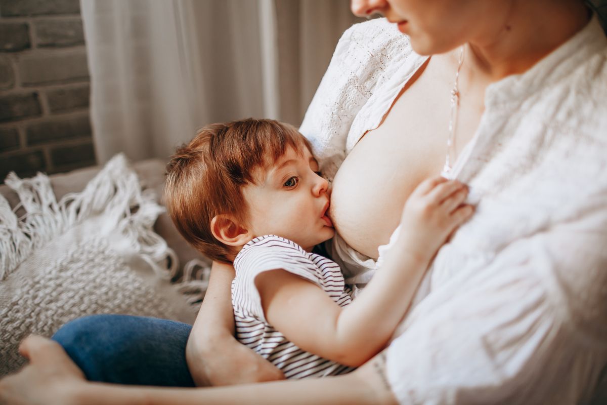 Mother nursing her baby in a relaxed home setting