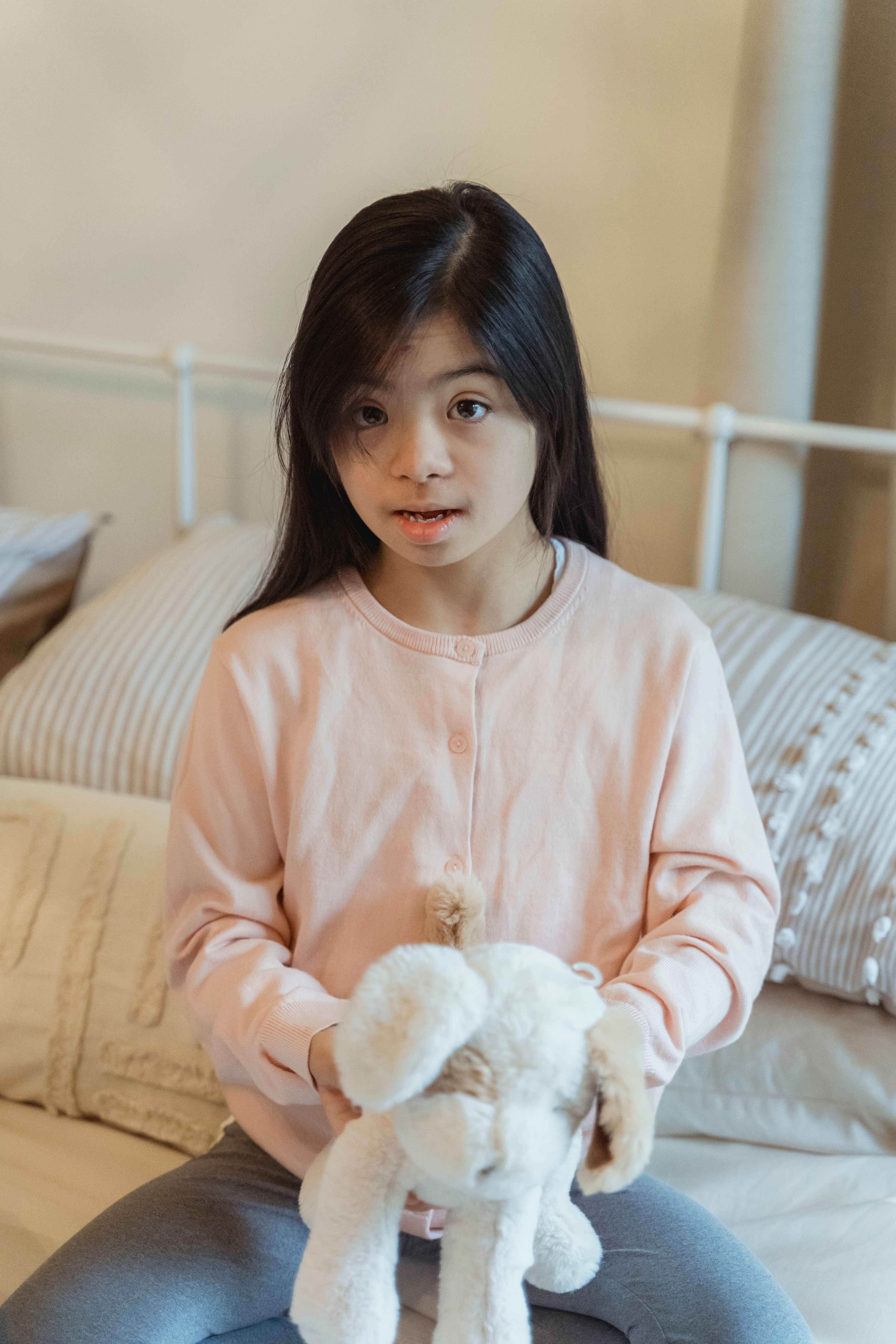 Portrait of a Girl Holding a Stuffed Toy · Free Stock Photo