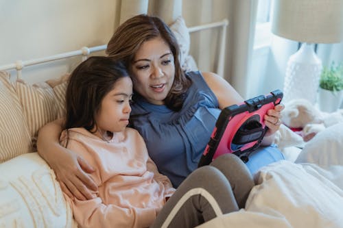 Free A Woman and a Young Girl using Tablet Together Stock Photo