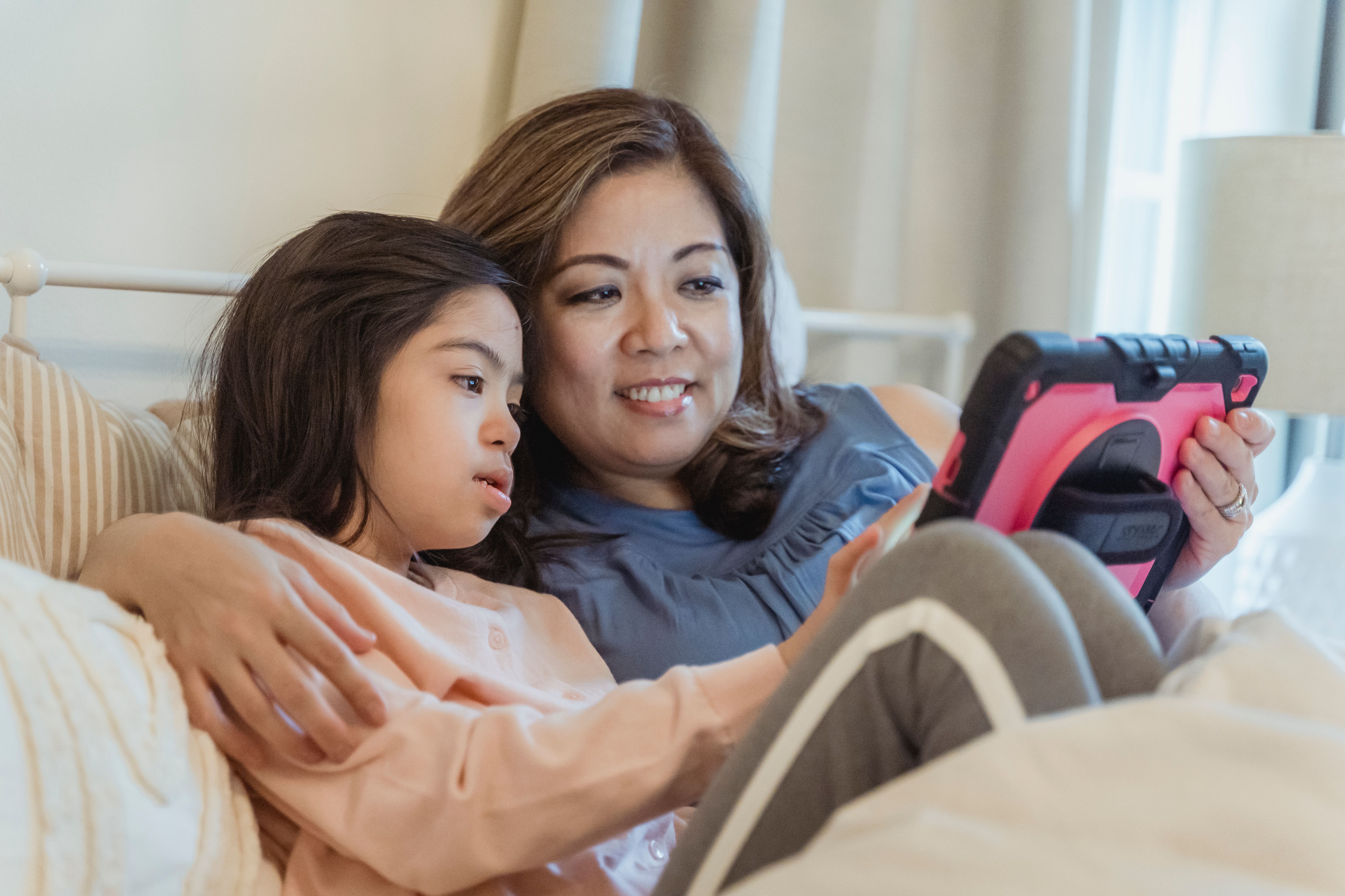 split screen of a parent looking tired and a child smiling at a Disney+ screen