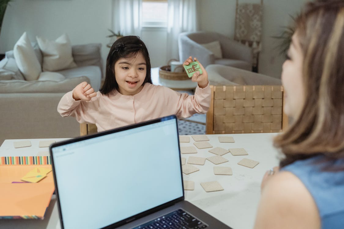 Free A Child Holding a Piece of Toy Sitting Stock Photo