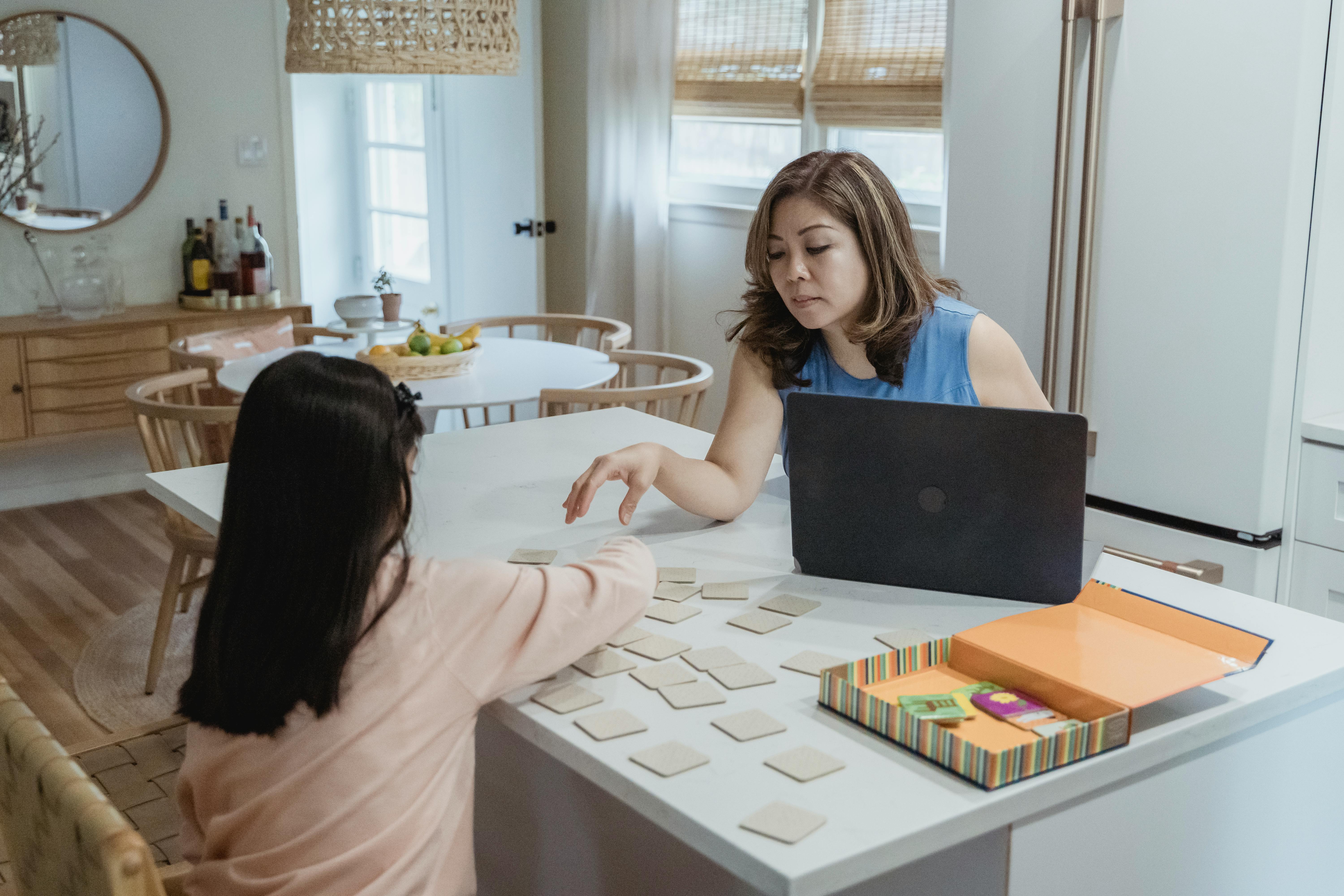 a mother looking at her daughter while working