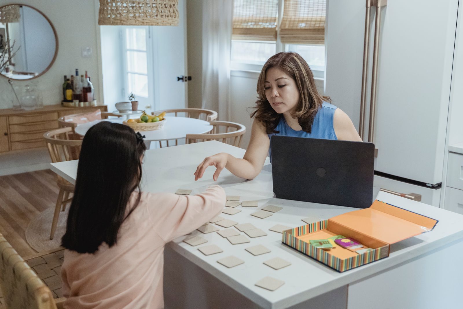 Parent and child enjoying a learning card game together at home