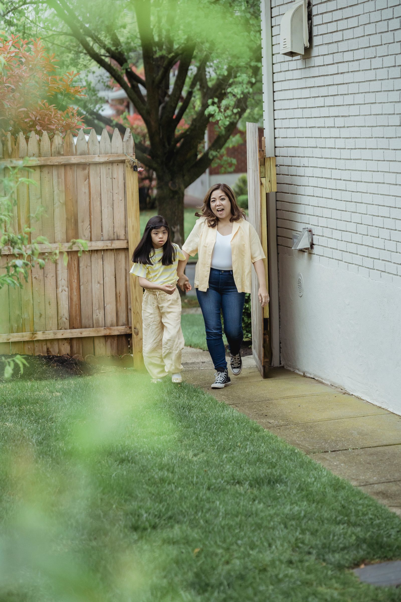 Mother and daughter walking together outdoors