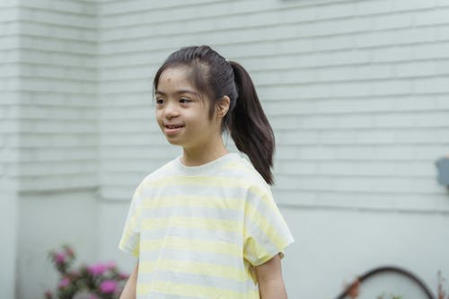 A Young Girl in Ponytail Hair Smiling