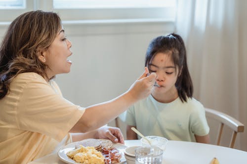 Free A Mother Feeding Her Daughter Stock Photo