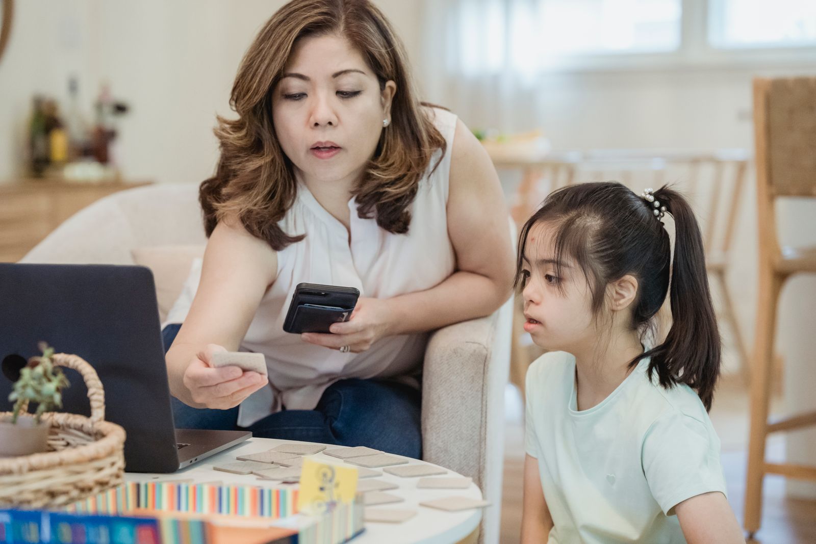 Parent and child using educational learning materials together at home